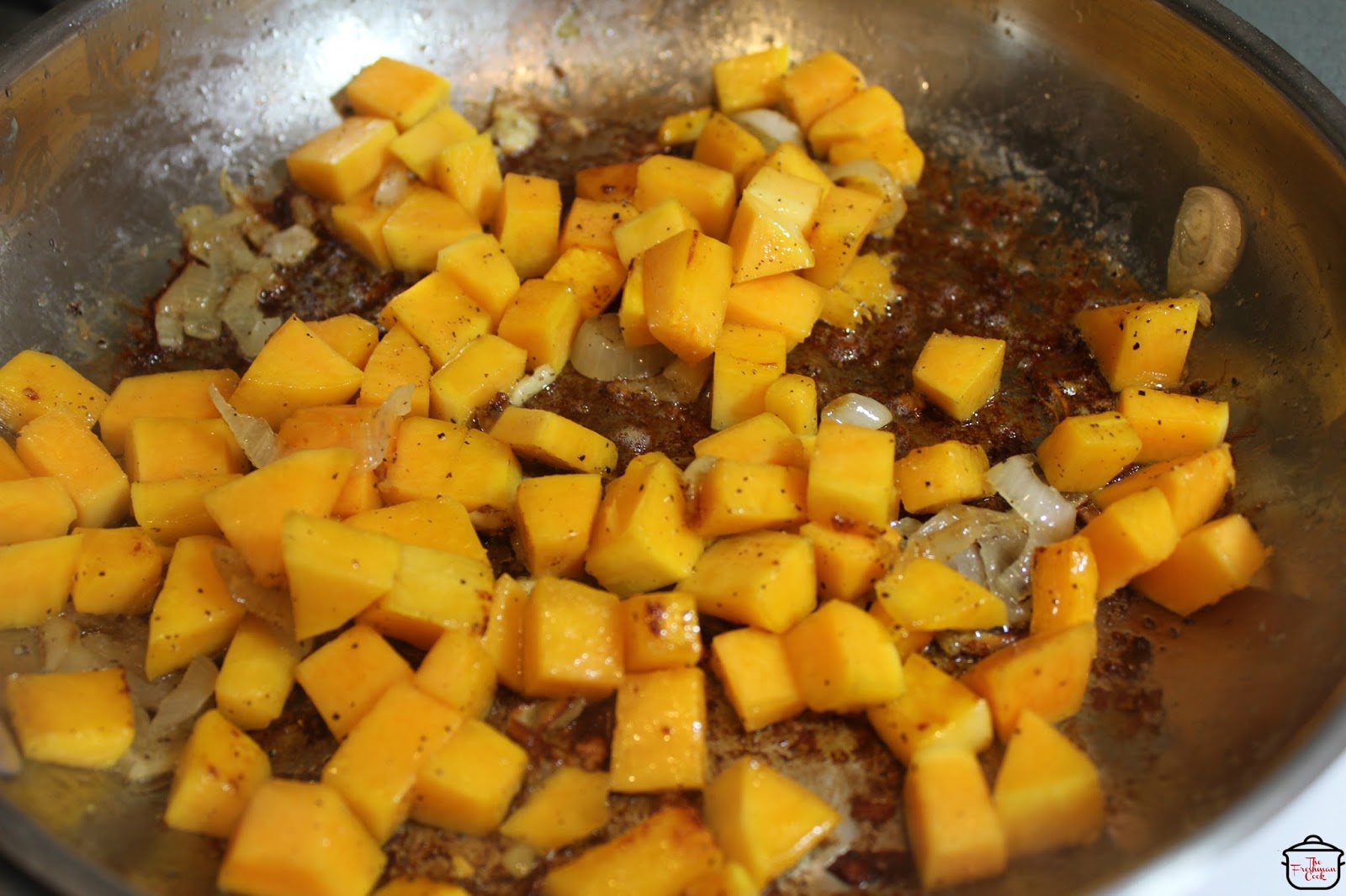 Cut and clean the butternut squash, then cube it into evenly sized pieces. Season with pepper and cook in the same skillet