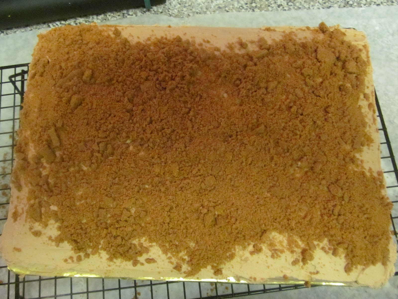 Press them over the top and sides of the frosted cake. If the frosting has crusted, lightly mist it with water so the crumbs adhere.