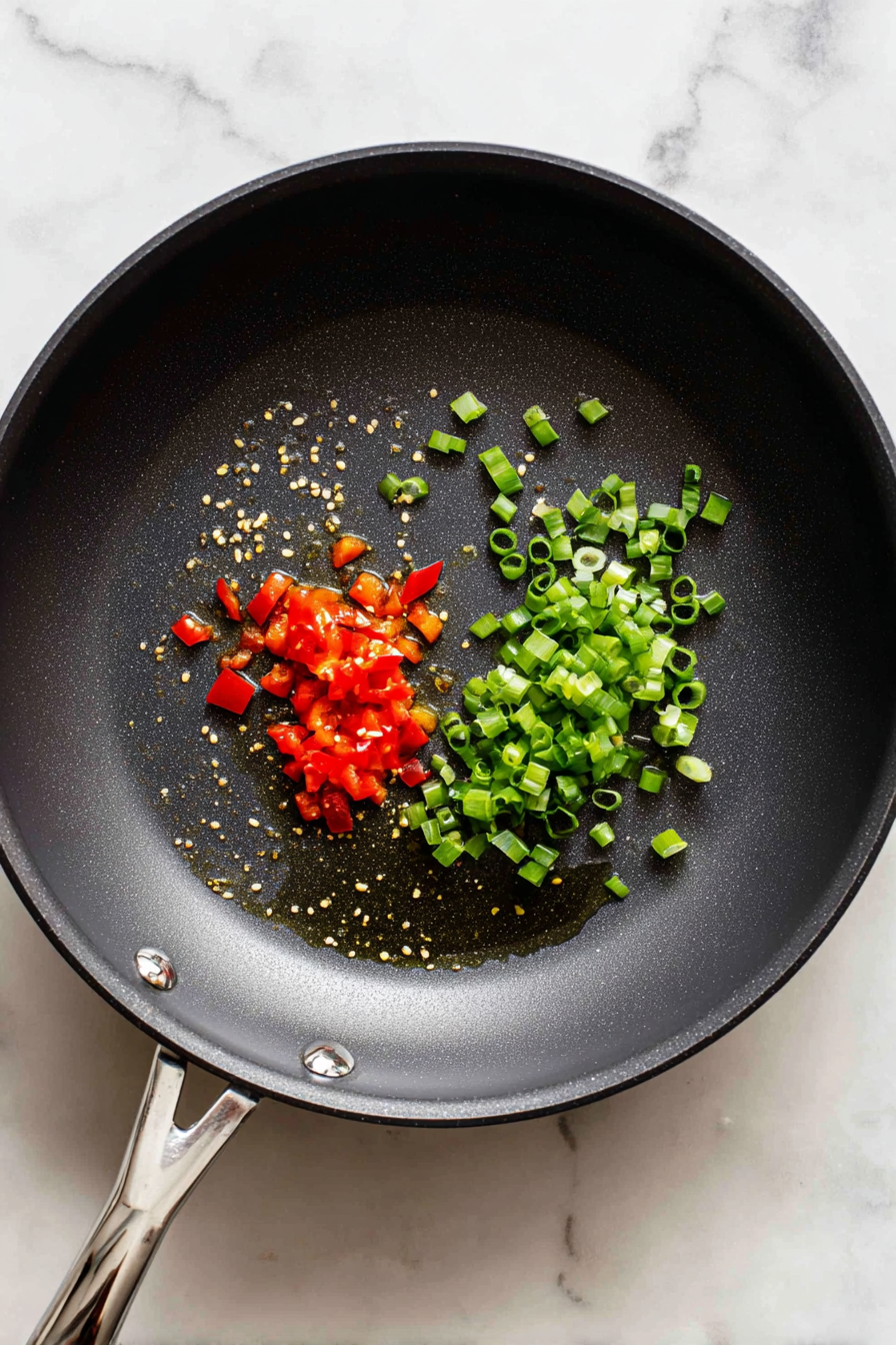 Stir in your green onion and peppers. Cook for 5 minutes or until tender.