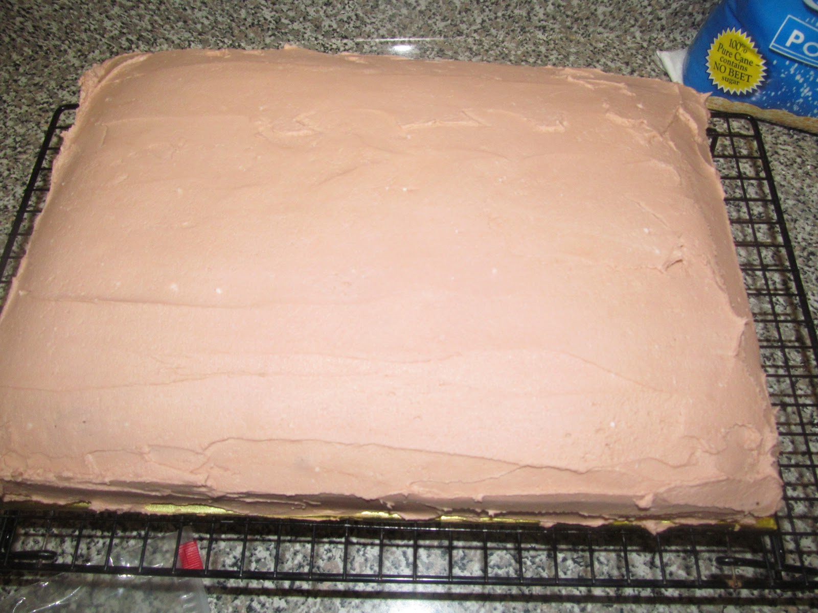 Tint the remaining frosting lightly brown to create a tan color, then frost the cooled cake