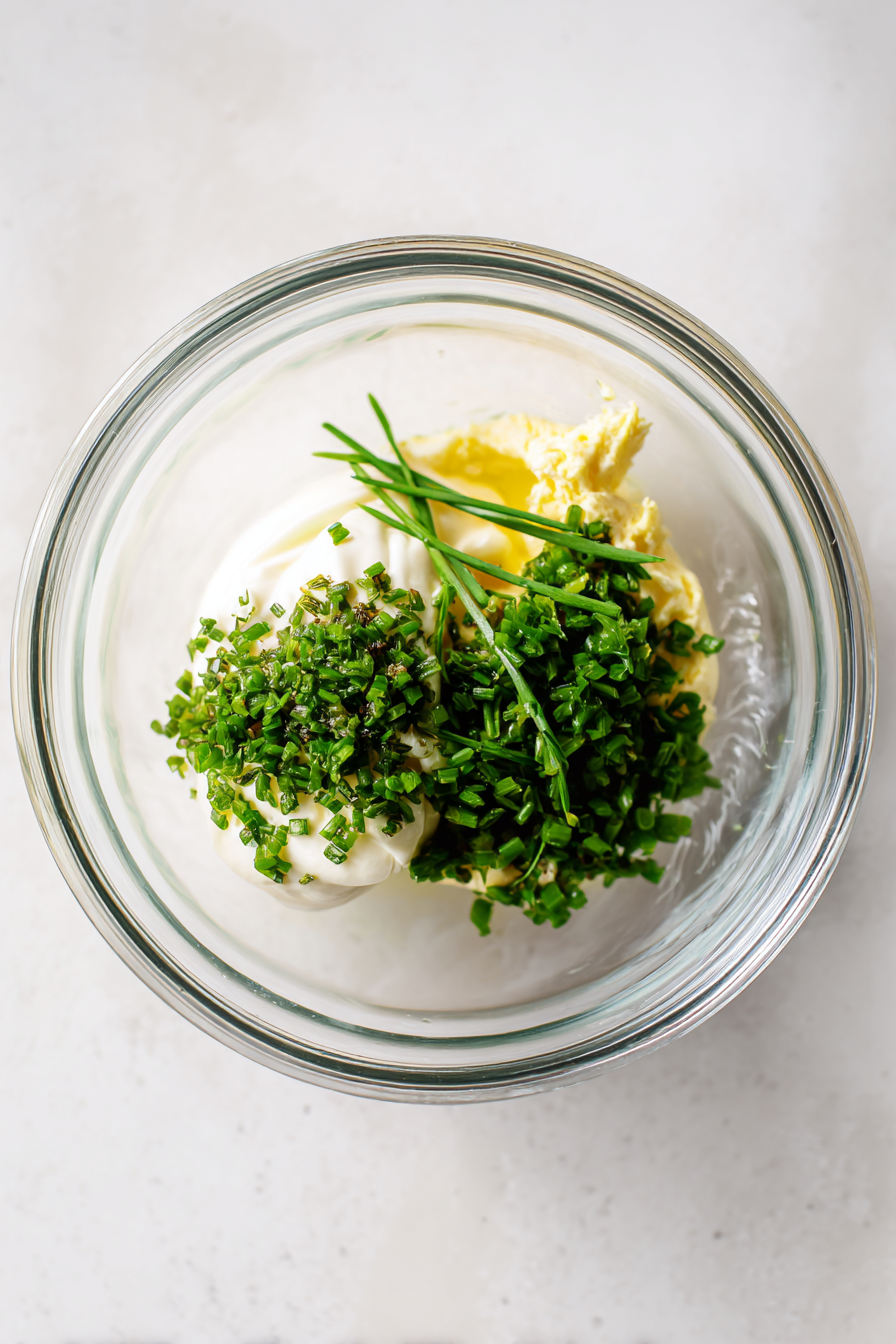 In a small bowl, mix together the Dijon mustard, mayonnaise, and chopped fresh herbs until well combined. Season with salt and pepper to taste.