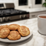 A container filled with freshly baked snickerdoodle cookies, stored airtight to maintain freshness for up to 7 days.