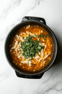 Return broth to the pot, add hominy, oregano, and shredded chicken; simmer for 20 minutes.