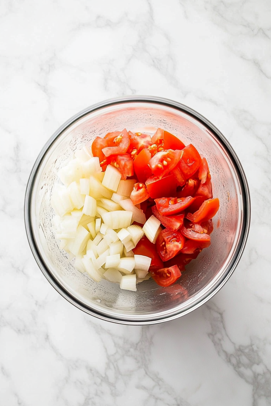 Blend onions, garlic, ginger, and tomatoes into a smooth paste.