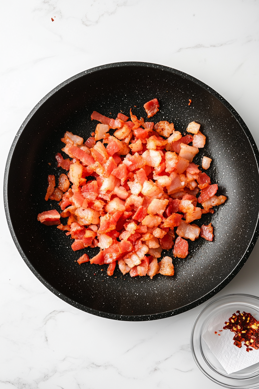 In a large skillet, cook chopped bacon until crispy; remove and drain on paper towels.
