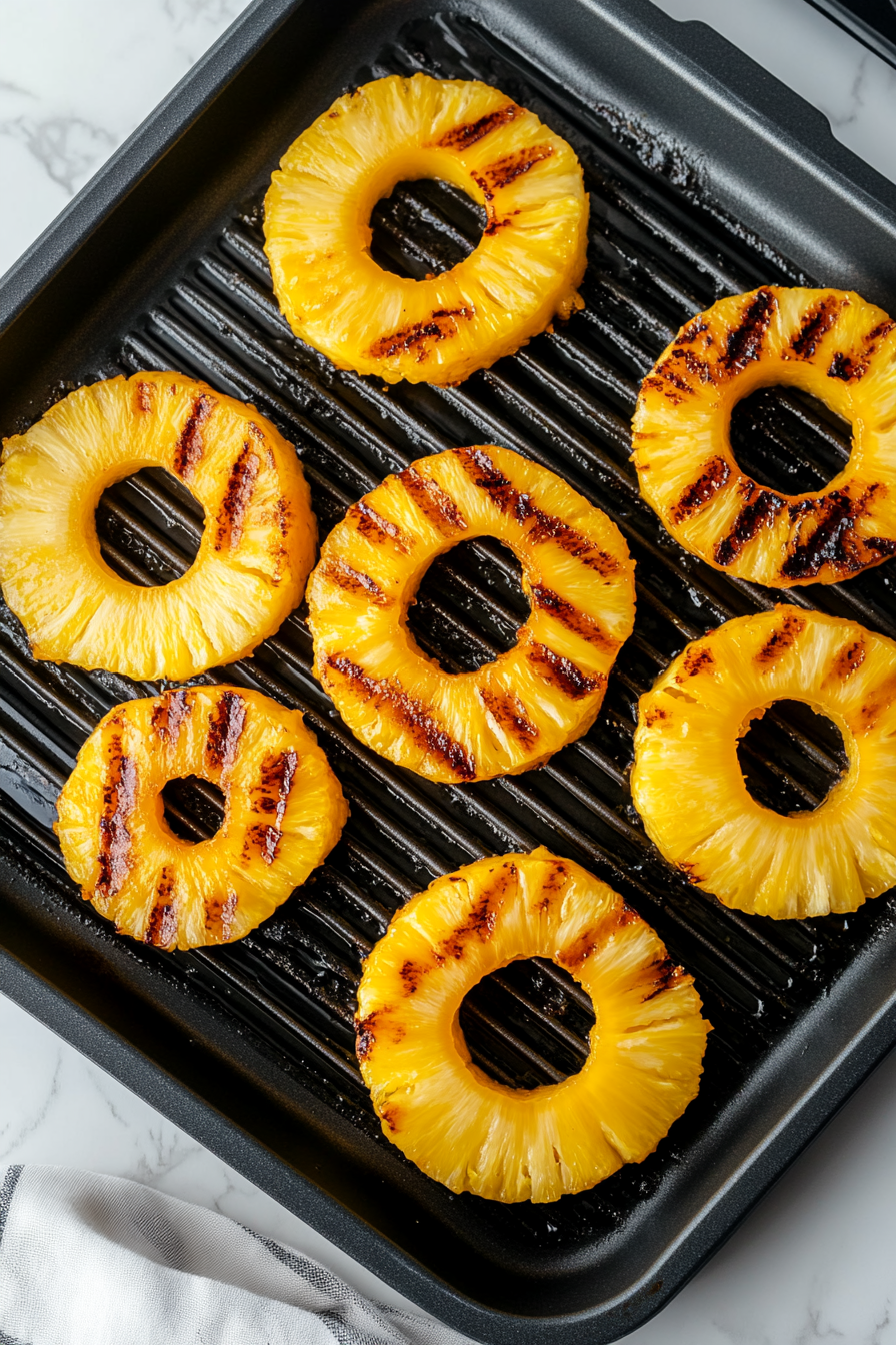 Grill pineapple rings until caramelized, about 1–2 minutes per side.