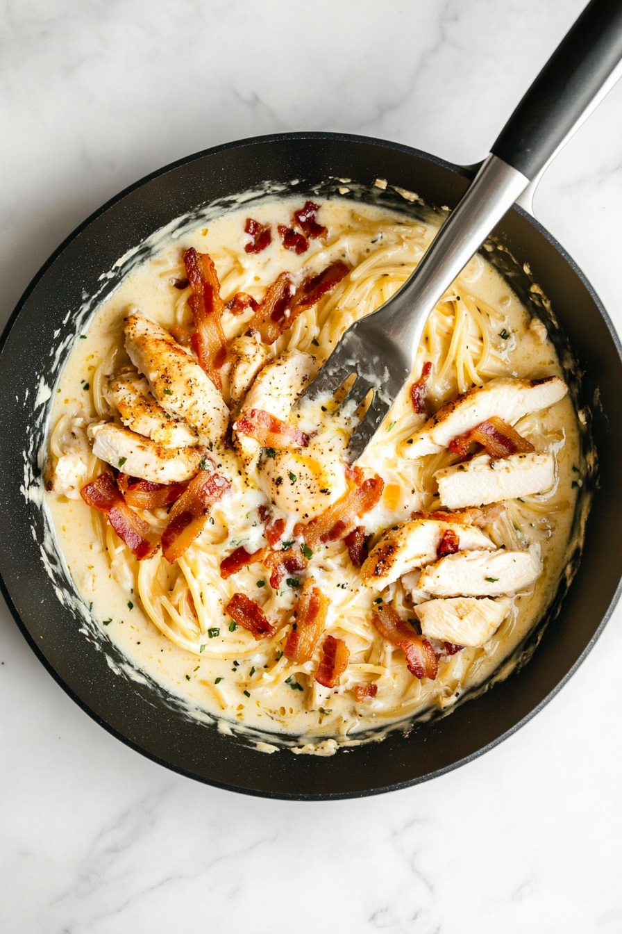 Stir in cooked chicken and bacon pieces until well combined and heated through.