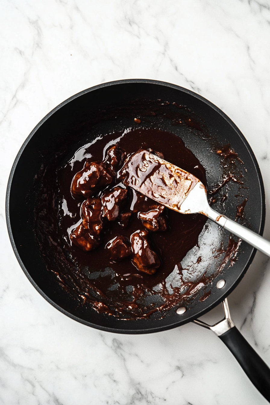 Pour the sauce over the chicken in the skillet; stir and cook until sauce thickens and coats the chicken.