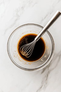 In a bowl, whisk together soy sauce, water, sesame oil, brown sugar, rice vinegar, grated ginger, garlic, and cornstarch to make the sauce.