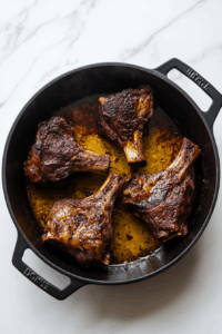 Heat oil in a pot and sear lamb on all sides until browned, then set aside.