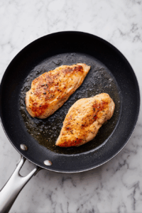 Add chicken breasts and sear until lightly golden on both sides.