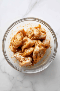 Add chicken thighs and coat well. Let marinate for at least 10 minutes.