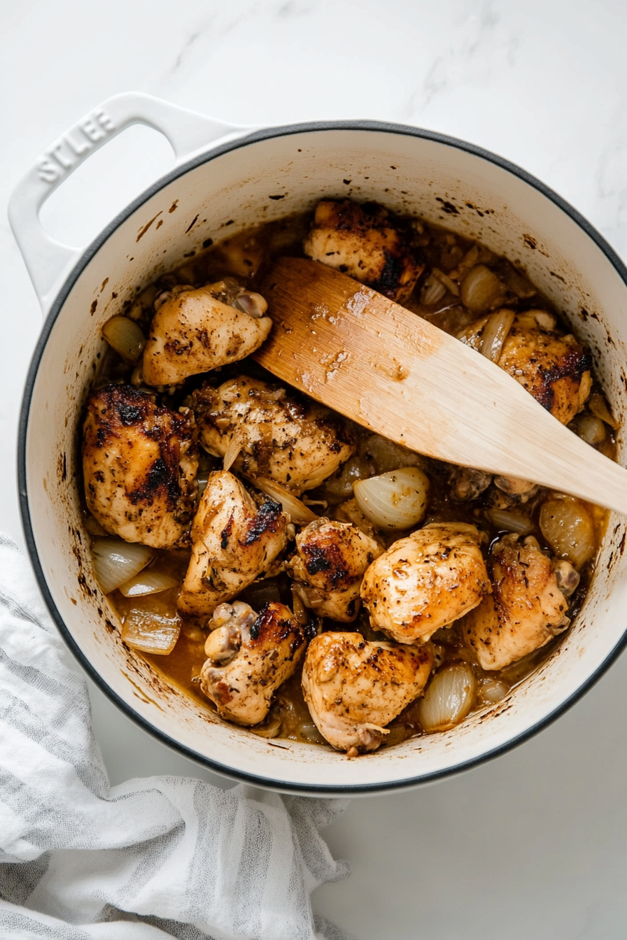 Add the skinless chicken thighs to the pot and mix well to coat.