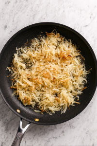 Add thawed hash browns, salt, and pepper. Cook until golden and crispy.