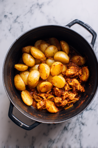 Add fried potatoes back to the pot and gently mix.