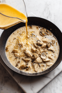 Pour in double cream and simmer until thickened.