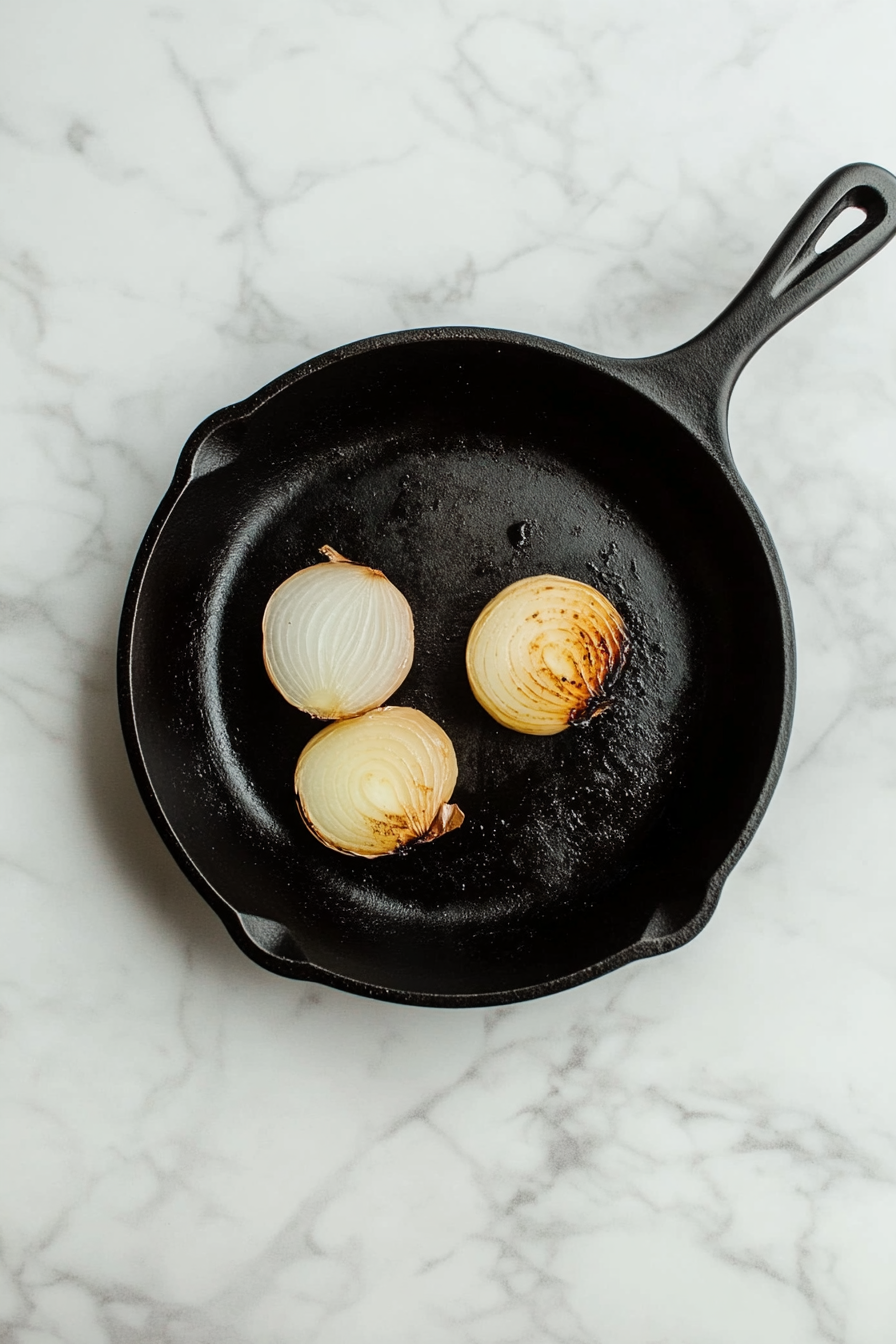Heat oil and char onion and ginger in a skillet until well browned.
