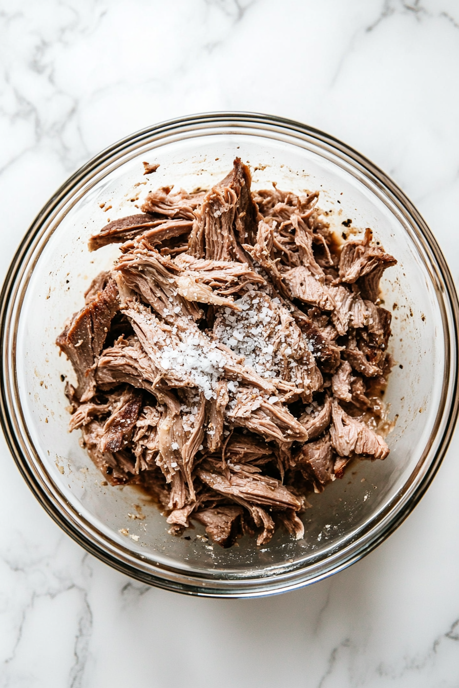 Coat the lamb pieces in cornflour, salt, and pepper.