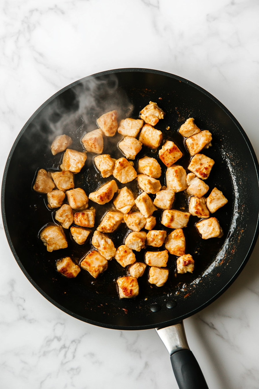Add chicken and cook until golden and cooked through, about 8–10 minutes.