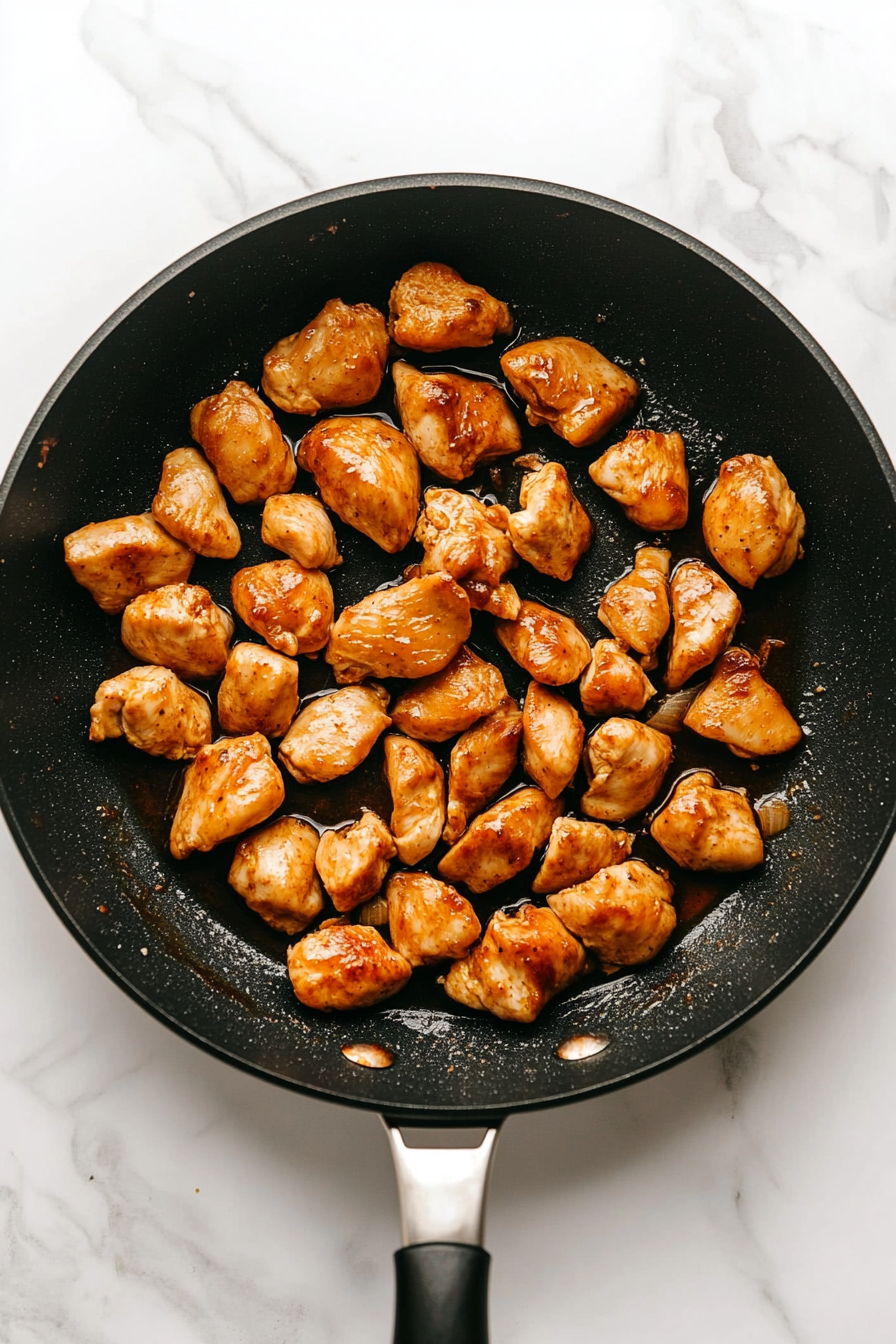Cook chicken pieces with oil, salt, and lime juice until tender.