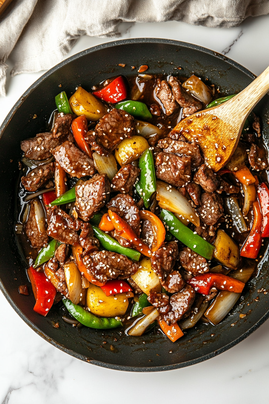 Combine: Return vegetables to the pan, pour in the sauce, and toss everything until the sauce thickens and coats the lamb and veggies evenly.