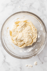 Combine all-purpose flour, salt, and water to knead a soft dough; set aside covered for 20 minutes.