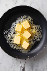 Melt butter in a large skillet over medium heat.