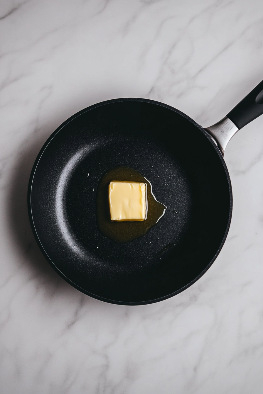 Heat butter in a large skillet over medium heat.
