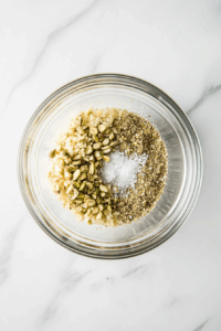 In a bowl, mix chopped pistachios and breadcrumbs with a pinch of salt and pepper.