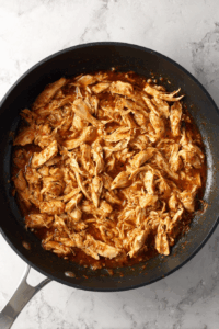 Return shredded chicken to the pan and mix into the sauce.