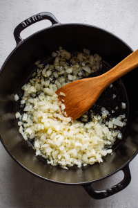 In the same pot, add remaining oil, sauté onions until soft.