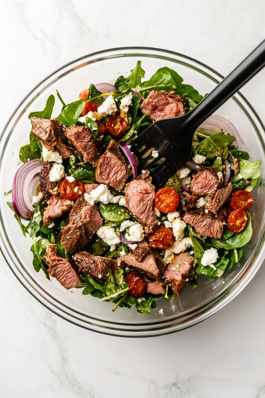 Toss the warm lamb into the salad.