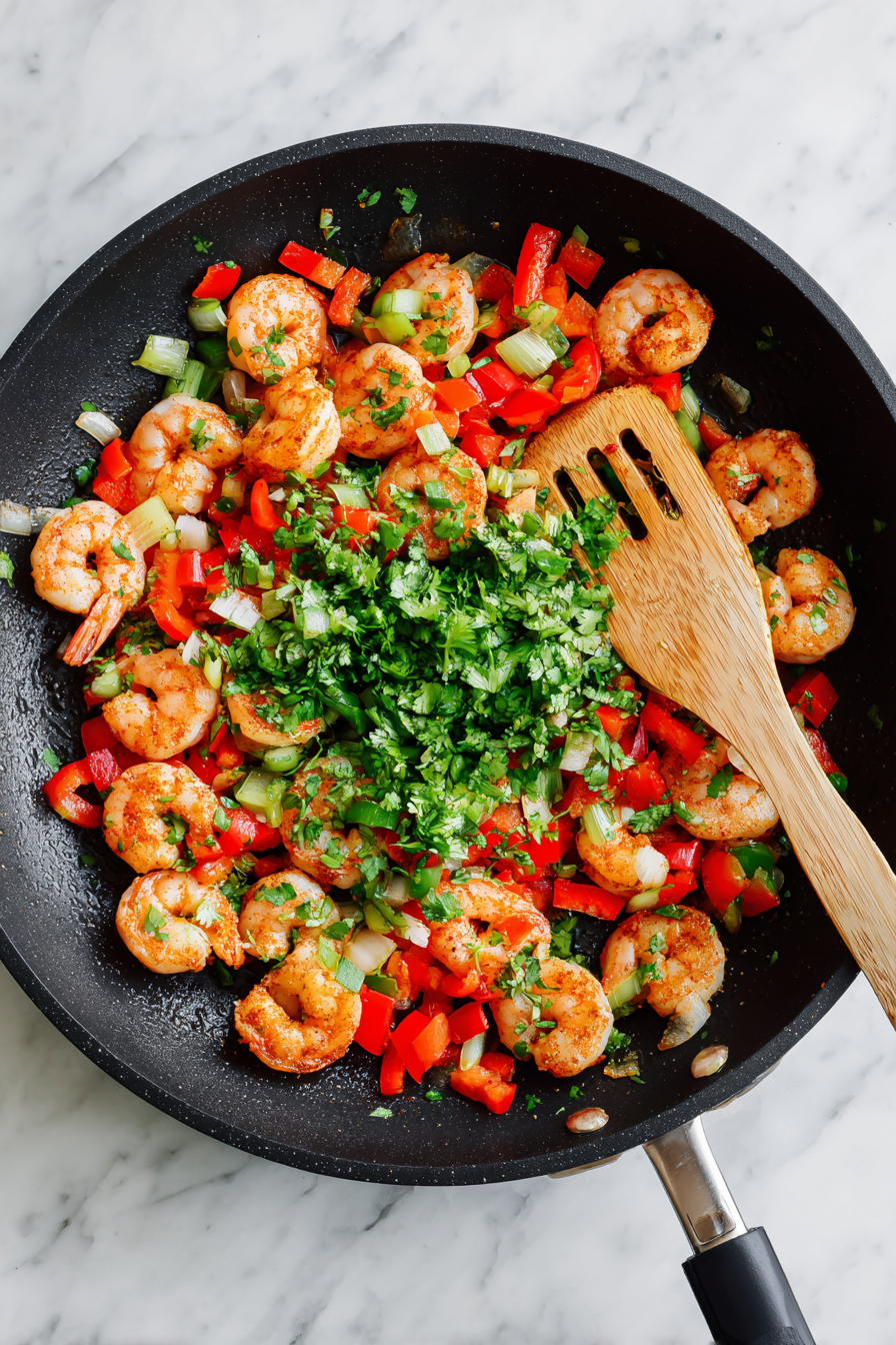 Add shrimp, chili powder, salt, lime juice, and cilantro cook until pink.