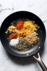 Add turmeric, chili powder, coriander, cumin powder, and salt; cook the masala base.