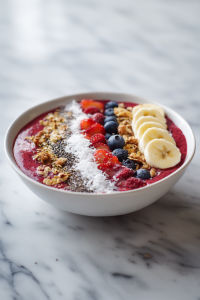 Top with shredded coconut, chia seeds, hemp seeds, fresh fruit, and granola. Serve immediately for best texture and taste. Enjoy your refreshing, nutrient-packed smoothie bowl!