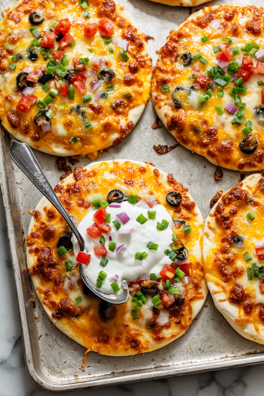 Garnish with diced tomatoes, green onions, olives, and a dollop of sour cream.