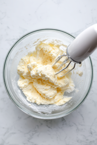 In a large bowl, cream together softened butter and sugar until light and fluffy.