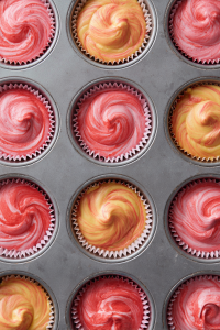 Spoon batters alternately into cupcake liners to create a marbled effect.