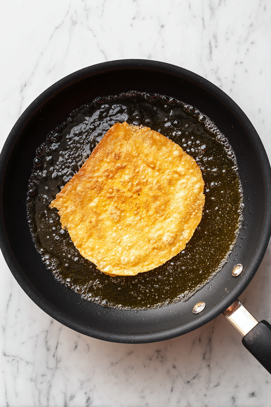 In a clean skillet, lightly fry tortillas in hot vegetable oil until golden and crisp; drain on paper towels.