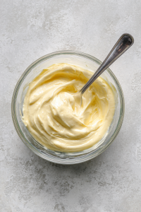 In a small bowl, mix mayo and Dijon mustard. Spread on bread slices.