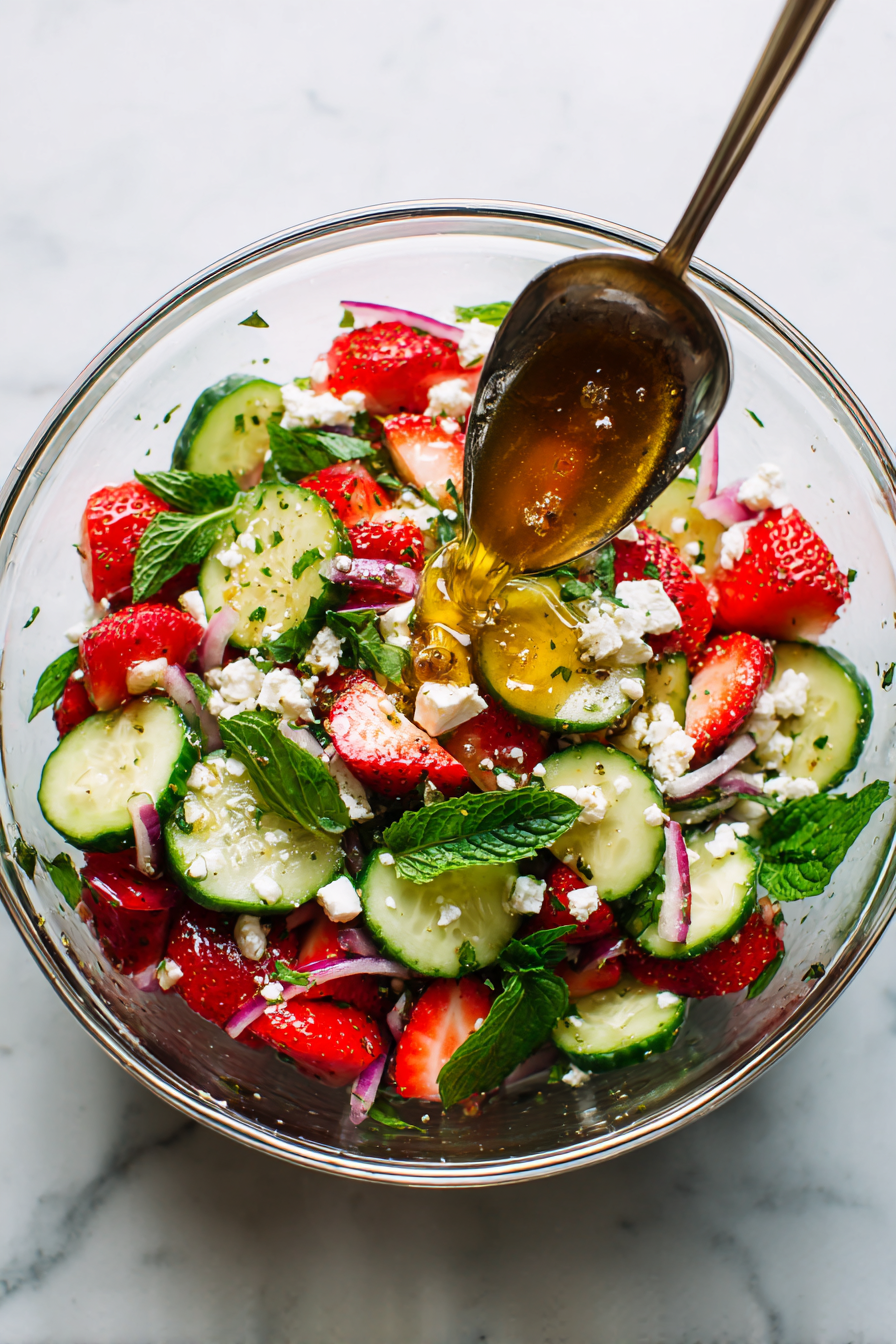Pour the dressing over the salad ingredients.