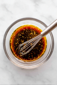 Meanwhile, mix soy sauce, vinegar, sugar, garlic, chili oil, sesame oil, and sesame seeds in a bowl.