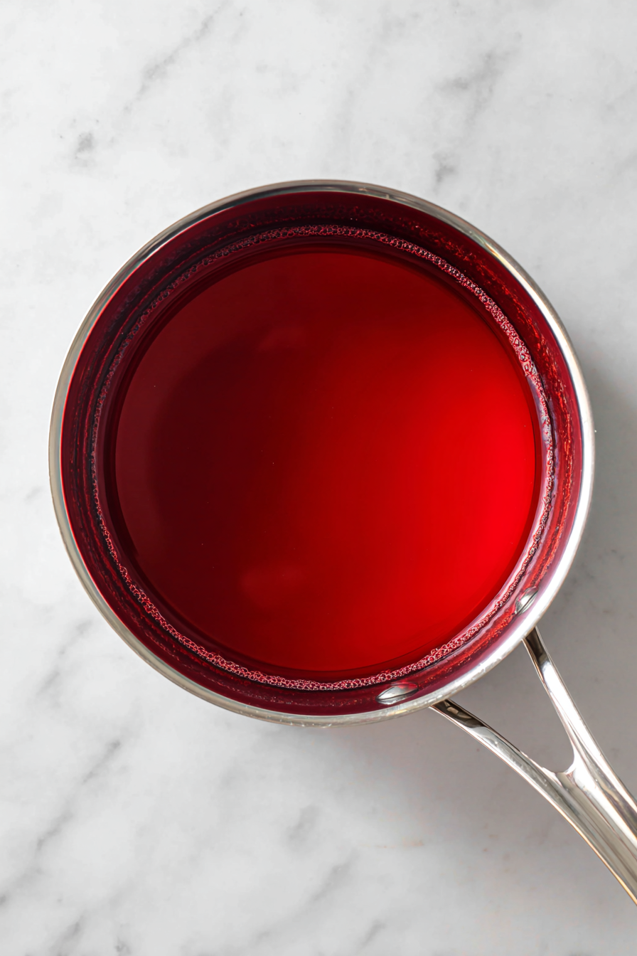 Prepare the Filling: In a saucepan, dissolve gelatin, sugar, and food coloring in boiling water. Mix cornstarch with cold water and stir into the gelatin. Cook until slightly thickened.