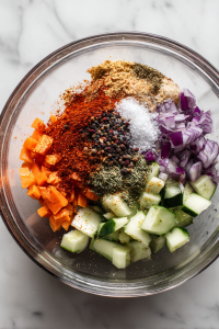 Add chopped green chili and fresh coriander leaves. Sprinkle Himalayan salt, roasted cumin powder, and black pepper or red chili powder.