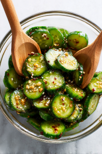 Add cucumbers to the dressing and toss well.