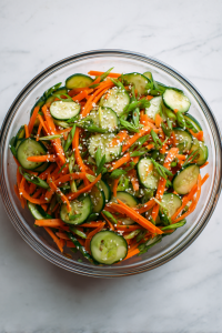 Combine the carrots, cucumbers, and green onions in a large bowl.