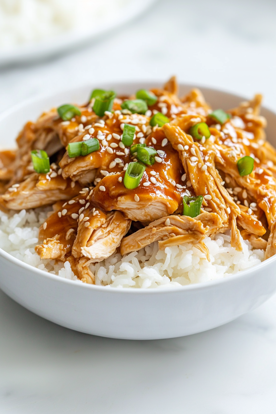 Spoon chicken and sauce over rice